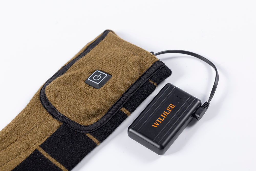 Wildler rechargeable battery pack with cable beside the sock cuff pocket and power button