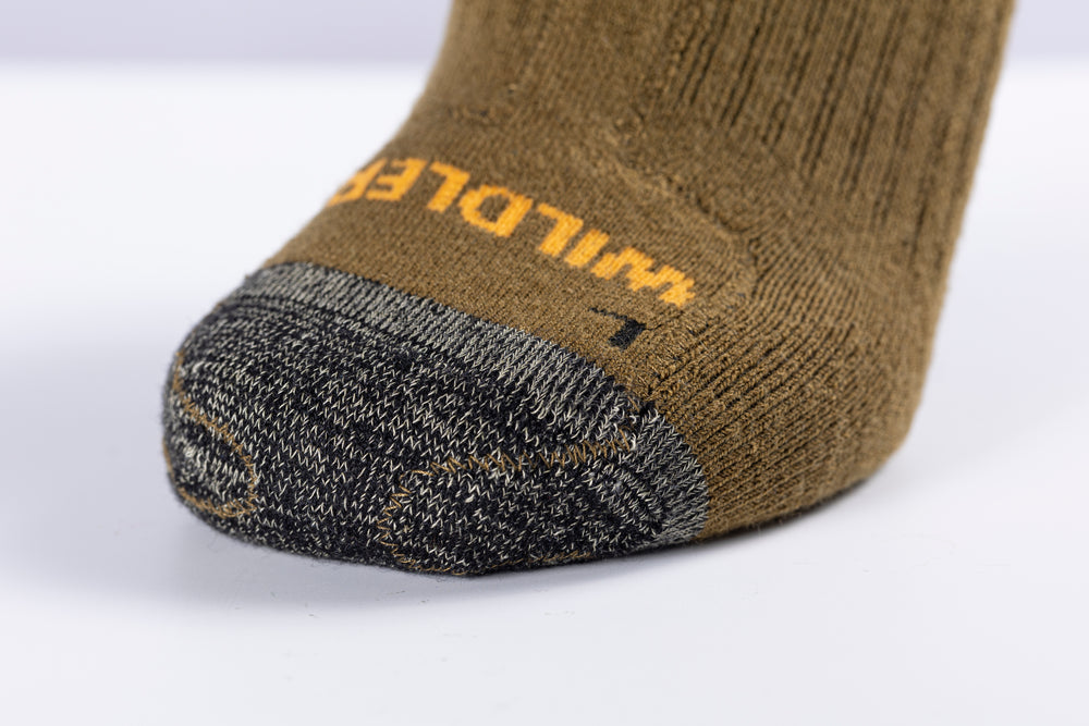 Close-up of the Wildler Heated Socks toe with orange WILDLER wordmark above the grey heathered toe