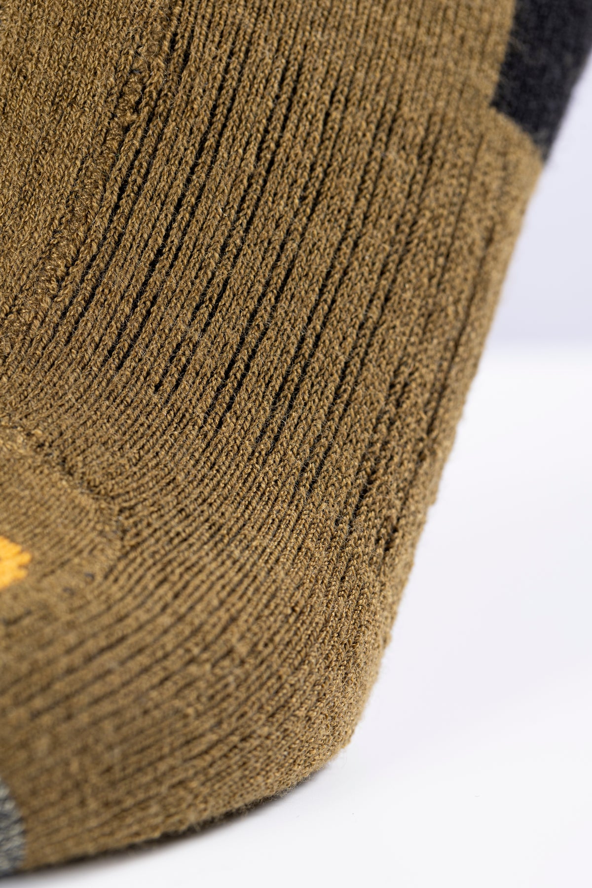 Macro detail of the merino-blend knit on Wildler Heated Socks in Brown