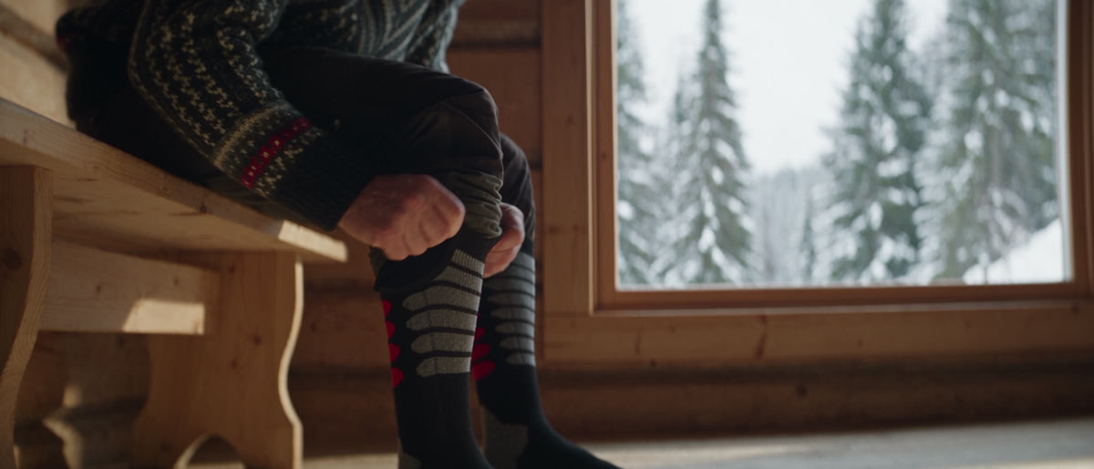 Wildler wireless heated socks worn in a sunlit cabin